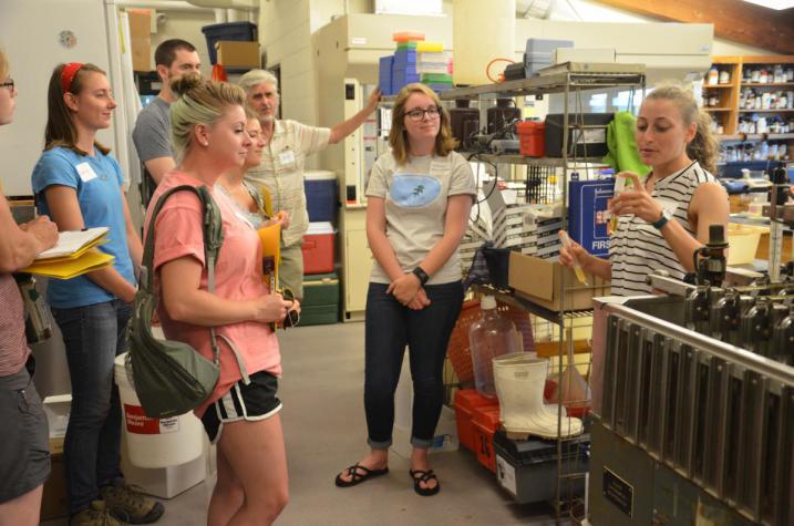 Students show volunteers how they process samples