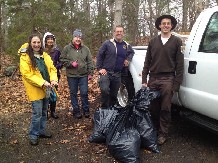 volunteers with trash bags of garlic mustard