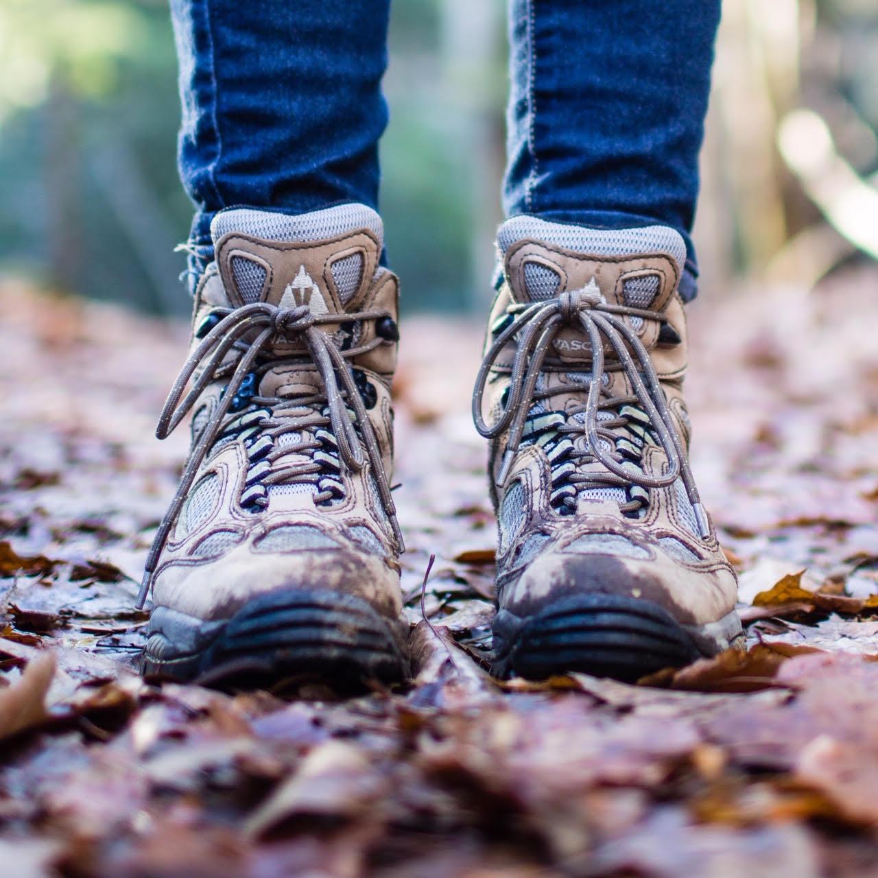 hiking boots on a leaf covered trail