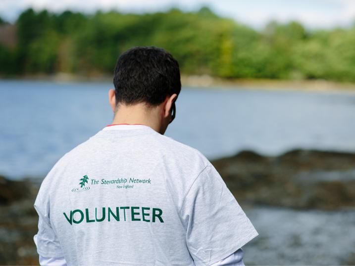 Volunteer shirt guy next to water