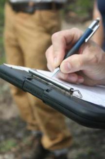 hand writing on clipboard