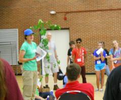 Ellen Snyder demontrating invasive plant removal inside at 4H event