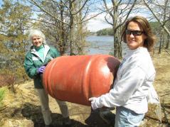 volunteers moving a barrel