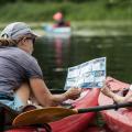 two kayakers looking at ID sheet