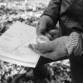 hand holding a compass and property map