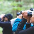 people using binoculars