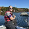 volunteer towing a dock in water