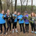 group of volunteers holding pulled garlic mustard