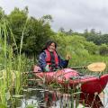 volunteer in kayak on lake smiling