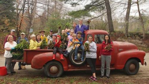 volunteers holding garlic mustard