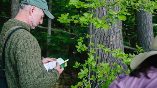 Citizen Science in action Man consulting field guide