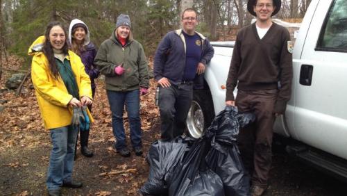 volunteers with trash bags of garlic mustard